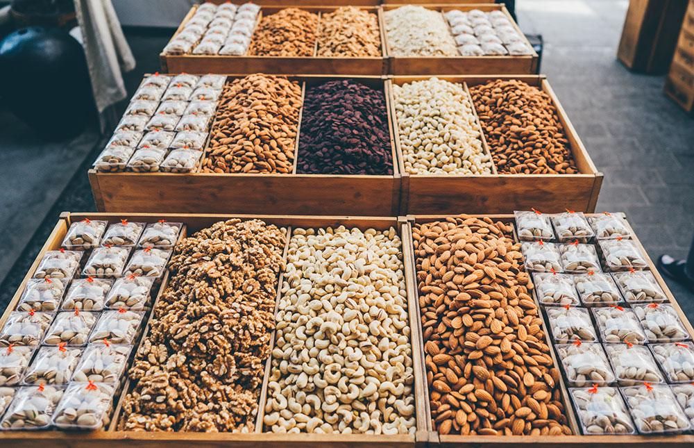 A display of assorted nuts and dried fruits in wooden boxes at the Numaish exhibition.